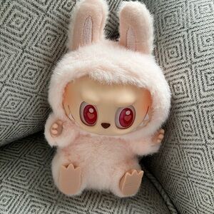 Labubu pink pop mart from “the monsters have a seat series.”